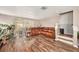 Living room with hardwood floors, a sectional sofa, and a view of the backyard at 8729 Sheldon Creek Blvd, Tampa, FL 33615