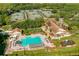 Aerial view of resort amenities featuring a pool and tennis courts at 9223 Highland Ridge Way, Tampa, FL 33647