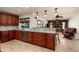 Spacious kitchen featuring granite countertops, dark wood cabinets, and stainless steel appliances at 9372 121St St, Seminole, FL 33772