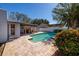 Large, rectangular pool with patio and covered seating at 9372 121St St, Seminole, FL 33772