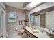 Bathroom with floral wallpaper, vanity, and shower/tub combo at 10020 Kenda Dr, Riverview, FL 33578
