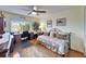 Bright bedroom with a daybed, built-in desk, and hardwood floors at 10020 Kenda Dr, Riverview, FL 33578
