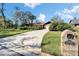 Inviting home exterior with mature landscaping and a long driveway at 10020 Kenda Dr, Riverview, FL 33578