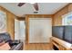 Living room with wood-paneled walls and a large TV at 10020 Kenda Dr, Riverview, FL 33578