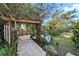 Brick patio with pergola, seating, and lush landscaping at 10020 Kenda Dr, Riverview, FL 33578