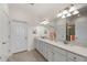 Double vanity bathroom with a large mirror and shower at 10043 Crooked Creek Dr # 202, Venice, FL 34293