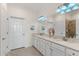 Double vanity bathroom with a large mirror and shower at 10043 Crooked Creek Dr # 202, Venice, FL 34293