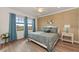 Spacious bedroom with large windows and wood-look floors at 10043 Crooked Creek Dr # 202, Venice, FL 34293
