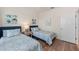 Bedroom with two twin beds and wood-look floors at 10043 Crooked Creek Dr # 202, Venice, FL 34293