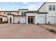 Exterior view of townhouses with attached garages and brick pavers at 10043 Crooked Creek Dr # 202, Venice, FL 34293