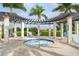 Relaxing hot tub surrounded by lounge chairs and pergola at 10043 Crooked Creek Dr # 202, Venice, FL 34293