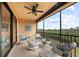 Screened lanai with wicker furniture and scenic view at 10043 Crooked Creek Dr # 202, Venice, FL 34293