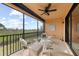 Screened lanai with wicker furniture and scenic view at 10043 Crooked Creek Dr # 202, Venice, FL 34293