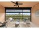 Screened lanai with wicker furniture and scenic view at 10043 Crooked Creek Dr # 202, Venice, FL 34293