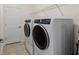 Laundry room with washer, dryer and storage shelves at 10043 Crooked Creek Dr # 202, Venice, FL 34293