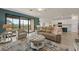 Living room features a view of the kitchen and access to a balcony at 10043 Crooked Creek Dr # 202, Venice, FL 34293