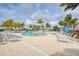 Relaxing pool area with lounge chairs and palm trees at 10043 Crooked Creek Dr # 202, Venice, FL 34293
