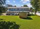 Spacious backyard with a shed and large lawn area at 1055 Philippe Pkwy, Safety Harbor, FL 34695