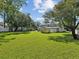 Large grassy backyard with a shed and mature trees at 1055 Philippe Pkwy, Safety Harbor, FL 34695