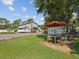 Outdoor patio area with a table, chairs, and a large umbrella at 1055 Philippe Pkwy, Safety Harbor, FL 34695