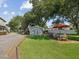 Large grassy backyard with a studio and patio furniture at 1055 Philippe Pkwy, Safety Harbor, FL 34695