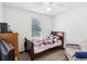 Bedroom with single bed, ceiling fan, and an armchair at 1055 Philippe Pkwy, Safety Harbor, FL 34695