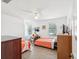 Bedroom with two twin beds, ceiling fan and wood-look flooring at 1055 Philippe Pkwy, Safety Harbor, FL 34695