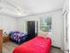 Bedroom with two twin beds, ceiling fan and large window at 1055 Philippe Pkwy, Safety Harbor, FL 34695