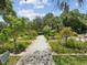 Landscaped garden path with lush greenery and flowers at 1055 Philippe Pkwy, Safety Harbor, FL 34695