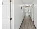 Long hallway with light gray vinyl flooring and white walls at 1055 Philippe Pkwy, Safety Harbor, FL 34695