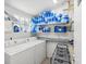 Laundry room with washer, dryer, and storage shelves at 1055 Philippe Pkwy, Safety Harbor, FL 34695