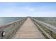 Wooden pier extending over calm waters towards a gazebo at 1055 Philippe Pkwy, Safety Harbor, FL 34695