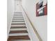 Clean, simple wooden stairs leading to upper level at 1055 Philippe Pkwy, Safety Harbor, FL 34695