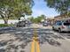 Residential street lined with mature trees and parked cars at 1055 Philippe Pkwy, Safety Harbor, FL 34695