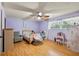 Light and bright bedroom with wood flooring and ceiling fan at 12519 Fairwinds Rd, Hudson, FL 34669