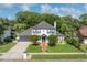 Two-story house with gray roof, brick walkway, and lush green lawn at 12908 Cinnimon Pl, Tampa, FL 33624