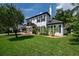 Two-story house with gray roof, white exterior, and manicured lawn at 12908 Cinnimon Pl, Tampa, FL 33624