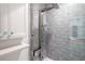 Spa-like shower with a rainfall shower head and tile surround at 12908 Cinnimon Pl, Tampa, FL 33624