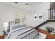 Cozy bedroom with paneled walls, loft access, and natural light at 14157 N Bayshore Dr, Madeira Beach, FL 33708