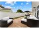 Spacious backyard with patio furniture and a grassy area at 15804 Redington Dr, Redington Beach, FL 33708