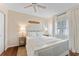 Bright bedroom with white platform bed and window seating at 15804 Redington Dr, Redington Beach, FL 33708