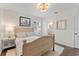Light and airy bedroom with wooden frame bed and en-suite bathroom at 15804 Redington Dr, Redington Beach, FL 33708