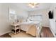 Cozy bedroom with a queen-size bed, hardwood floors and plantation shutters at 15804 Redington Dr, Redington Beach, FL 33708