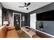 Stylish game room featuring a leather sofa and built-in shelving at 15804 Redington Dr, Redington Beach, FL 33708