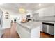 Modern kitchen with white cabinets, granite countertops, and a large island at 15804 Redington Dr, Redington Beach, FL 33708