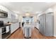 Modern kitchen with white cabinets, granite countertops, and stainless steel appliances at 15804 Redington Dr, Redington Beach, FL 33708