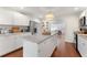 Modern kitchen with white cabinets, granite countertops, and a large island at 15804 Redington Dr, Redington Beach, FL 33708