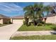 One-story house with attached garage and palm trees at 1622 Redmond Brook Ln, Ruskin, FL 33570