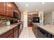 Well-equipped kitchen showcasing a center island and dark wood cabinetry at 1622 Redmond Brook Ln, Ruskin, FL 33570