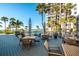 Relaxing pool deck area with tables, chairs and beach access at 1660 Gulf Blvd # 307, Clearwater Beach, FL 33767